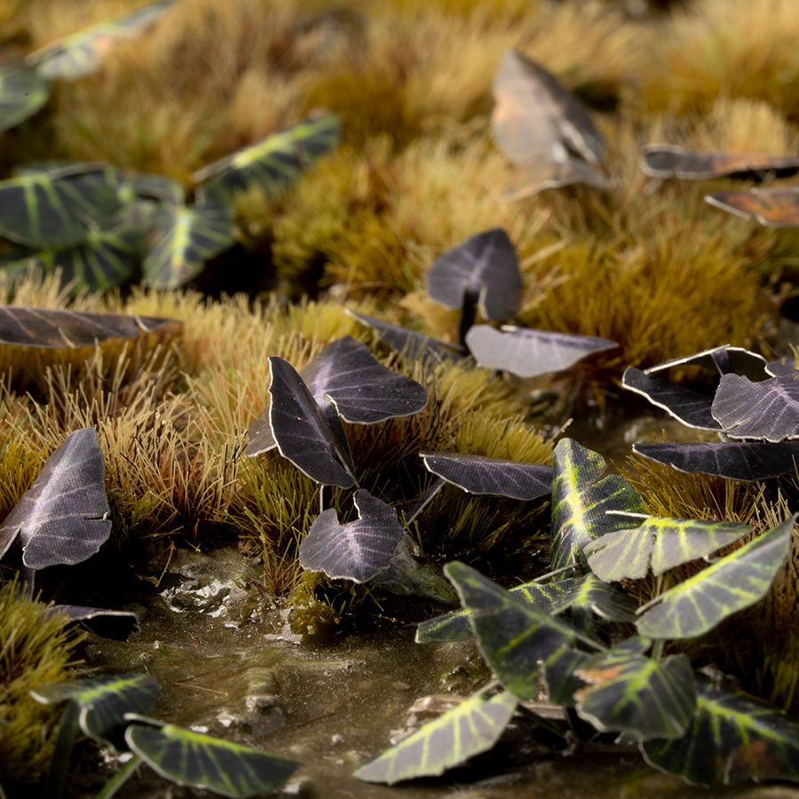 Miniature terrain featuring assembled Black Magic Taro laser-cut plants integrated into a realistic scenic landscape.