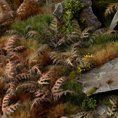 Miniature terrain featuring assembled Dry Bracken laser-cut plants integrated into a realistic scenic landscape.