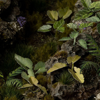 Miniature terrain featuring assembled Elephant Ear laser-cut plants integrated into a realistic scenic landscape.