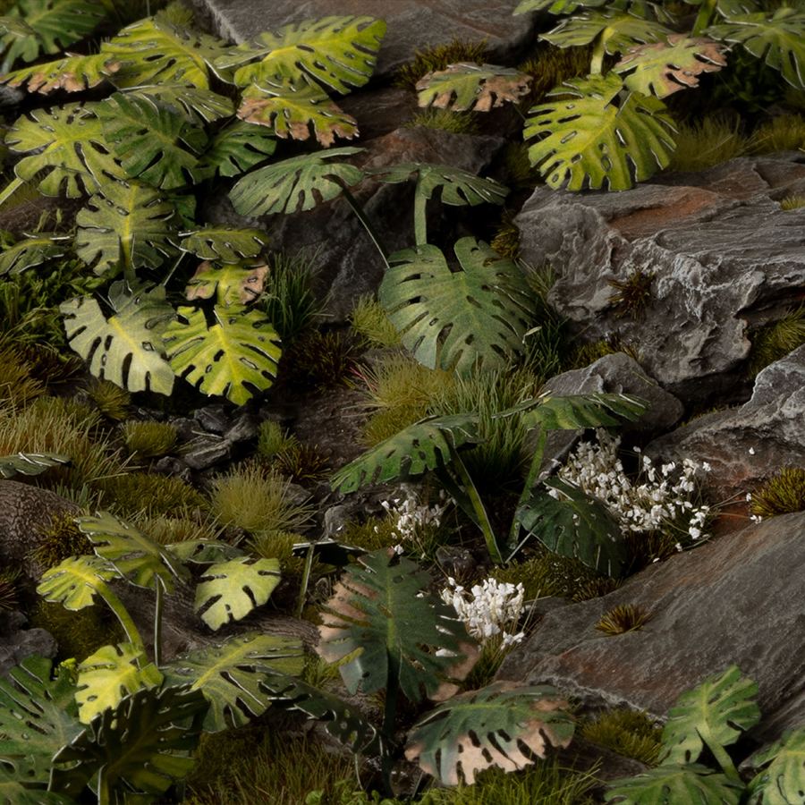 Miniature terrain featuring assembled Monstera laser-cut plants integrated into a realistic scenic landscape.